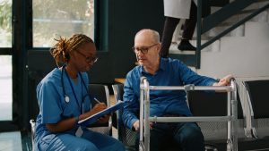 female nurse doing checkup consultation with old patient