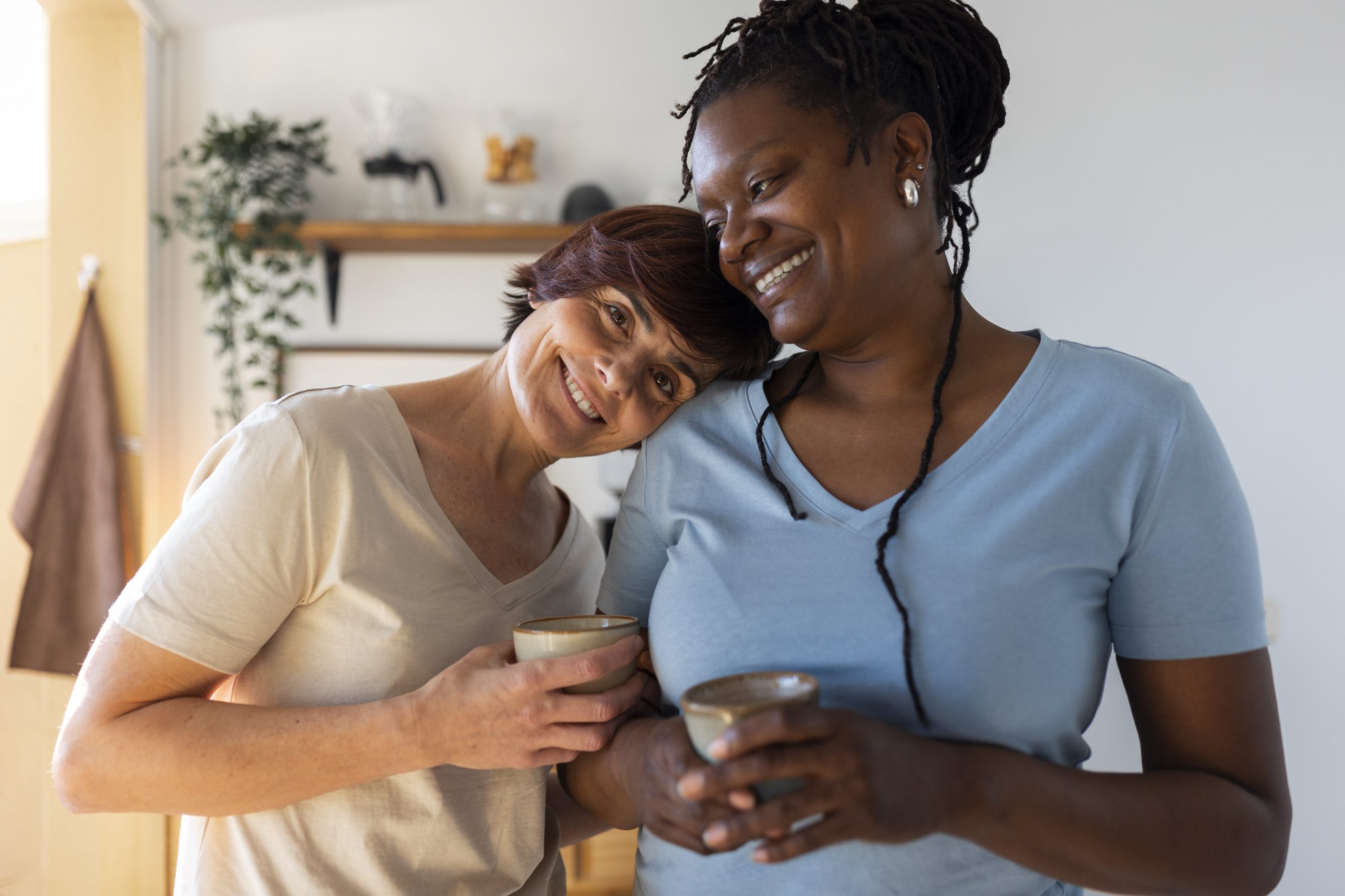 front view lesbian couple with coffee cups
