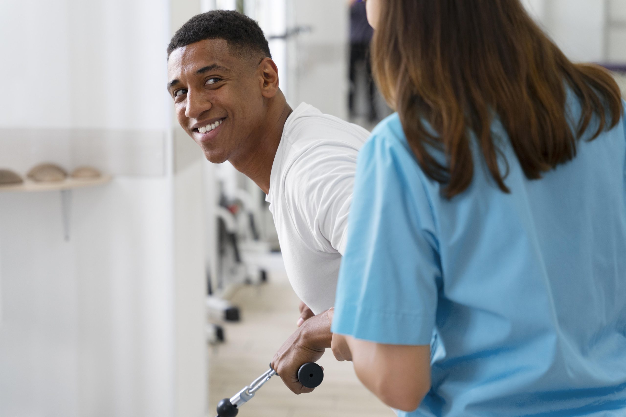 medical assistant helping patient with physiotherapy exercises